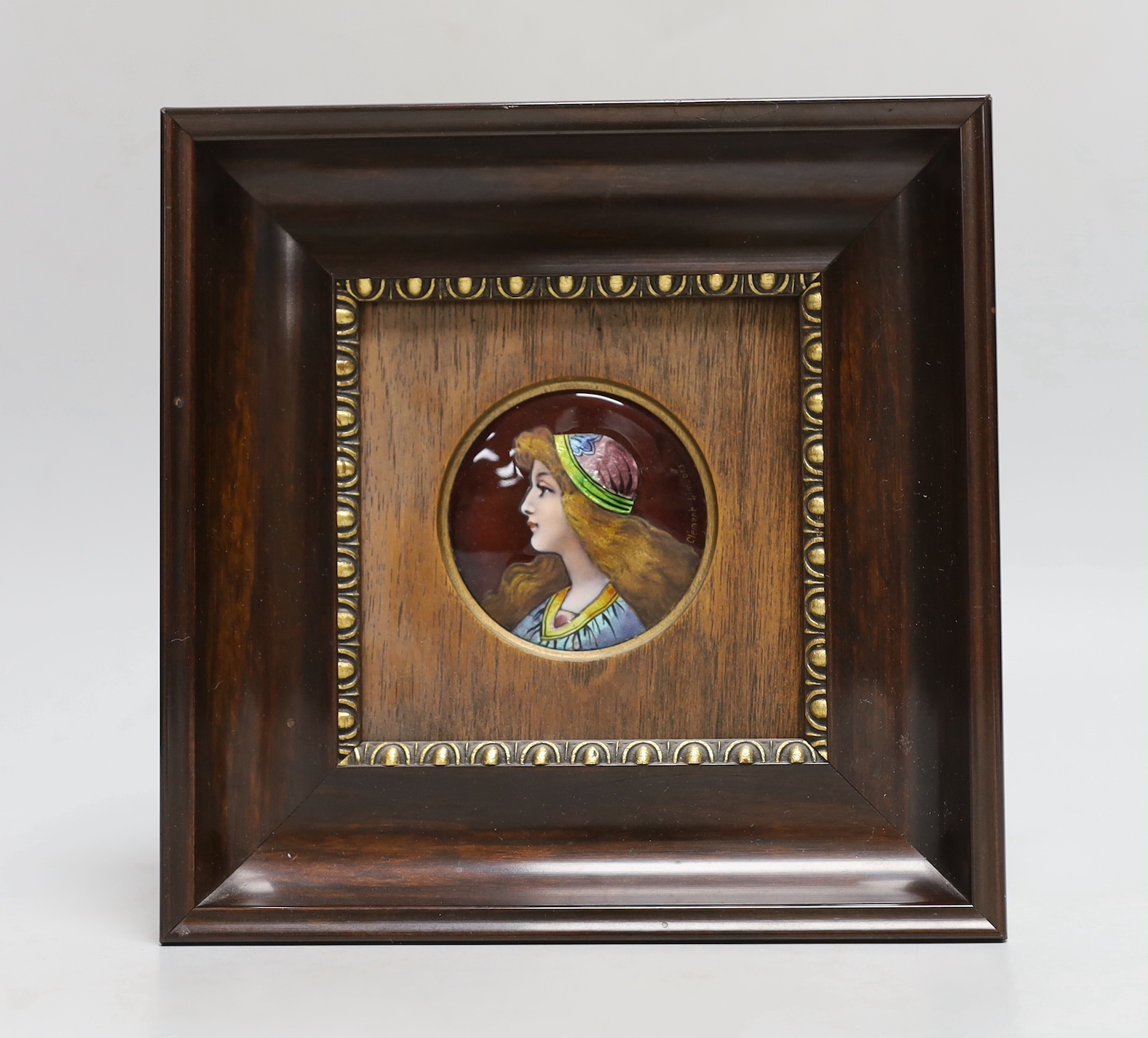 Clement Limoges: An Arts and Crafts enamelled circular plaque, of pre-Raphaelite girl, framed, plaque 5.5cm diameter